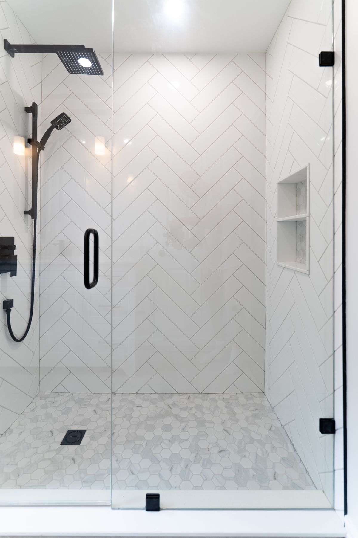 Herringbone tile bathroom renovation by Coronation Construction, photographed by Mike Mala