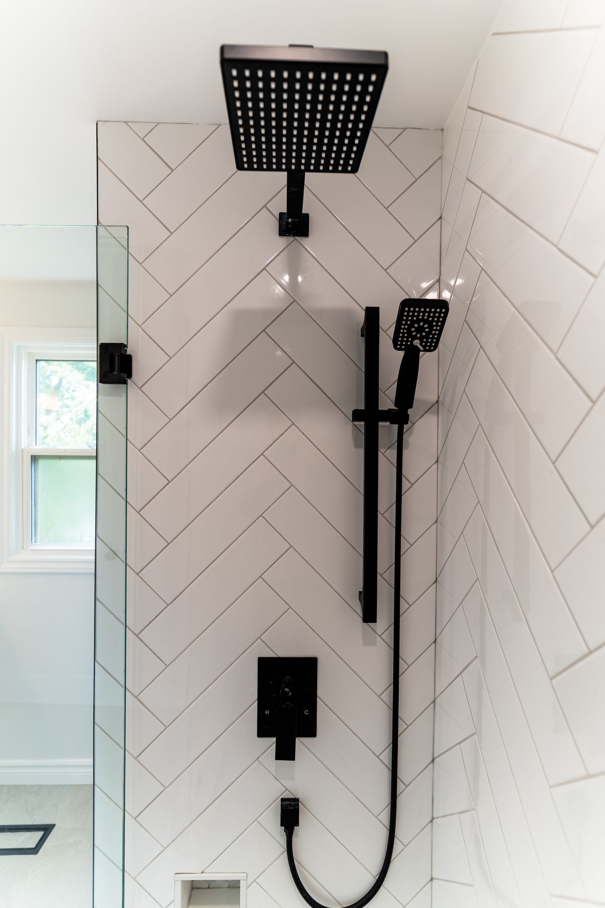 Herringbone tile bathroom renovation by Coronation Construction, photographed by Mike Mala